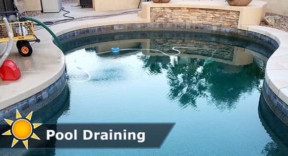 Swimming pool with pool draining equipment ready to perform