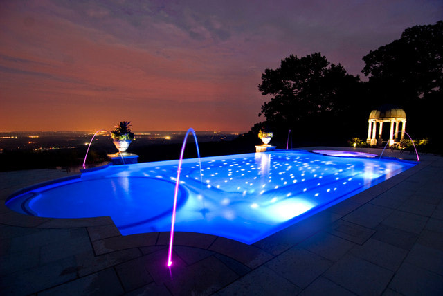 Purple and blue swimming pool lighting at night