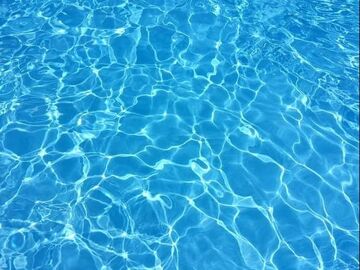 An image of a clear blue swimming pool 